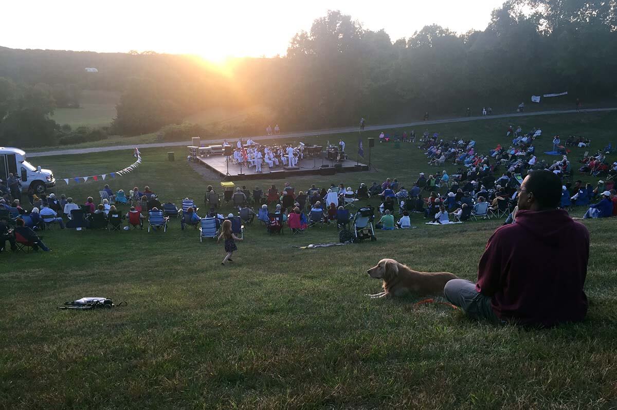 Shawn and Golden Retriever watching a Navy Band Concert